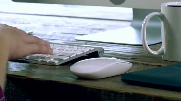 A Caucasian Male Typing on a Wireless Keyboard 14 alt