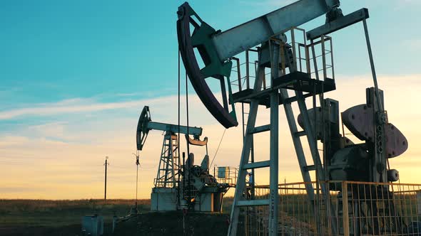 Metal Units Are Pumping Oil at the Development Site. Oil Well, Crude Oil, Drilling Rig, Oil Field alt