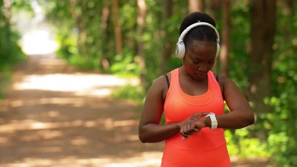 African Woman with Headphones and Smart Watch alt