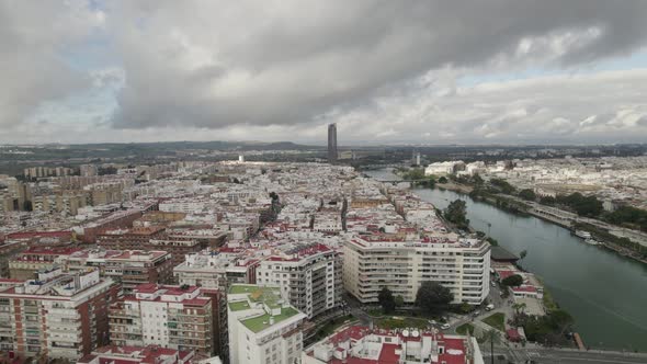 Seville skyline with Sevilla Tower standing out at distance. Aerial view