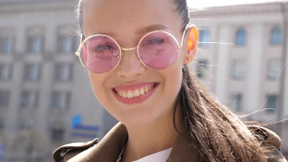 Beautiful smiling brunette model dressed in summer hipster jacket and jeans alt