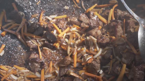 Cooking Meat With Vegetables In A Cauldron alt