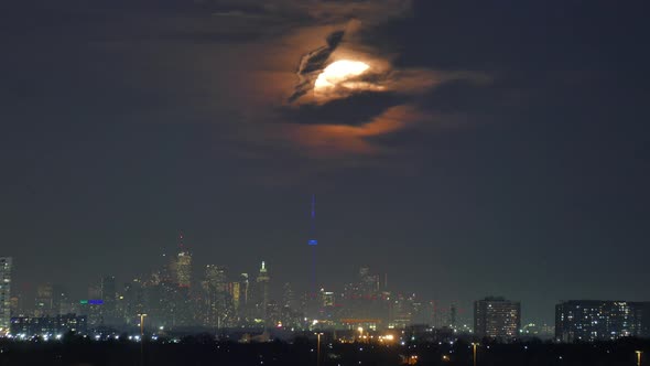 Time lapse of giant moon rising over Mississauga, Toronto, Canada, wide shot alt