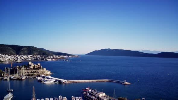 View from drone on full of yachts Bodrum harbour and ancient Kalesi castle in Mugla in Turkey alt