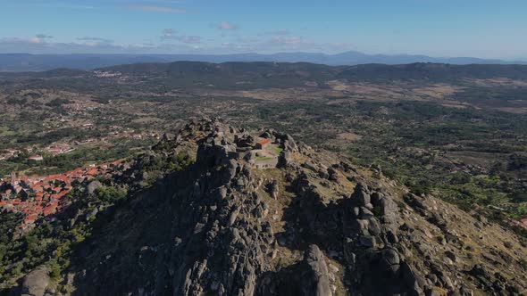 Aerial forward over Monsanto castle ruins with valley in background, Portugal alt