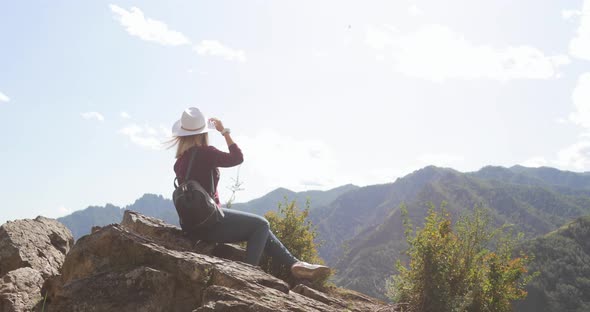 Woman Sitting on Top of Mounting Admiring Amazing View on Valley, Hills, River