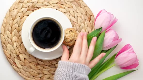 Woman Hands Cup of Coffee Cookies Flowers Pink Tulips on White Background alt