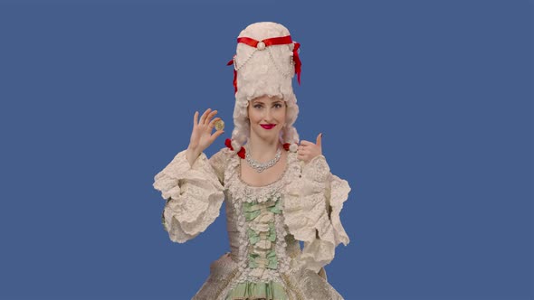 Portrait of Courtier Lady in Vintage Dress and Wig Showing a Bitcoin Coin and Making Thumbs Up alt