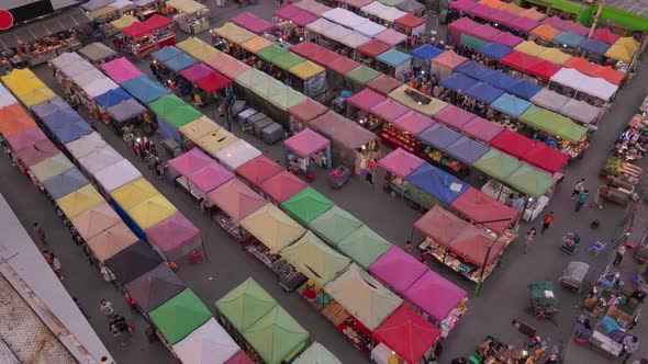 Time lapse of aerial top view of Night Market people walking street, Colorful tents alt