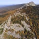 Aerial view of the mountains with rocks and beautiful autumn woods on the slopes - VideoHive Item for Sale