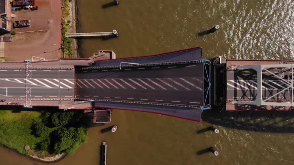 Top View Of A Bascule Bridge Opening Over Noord River In Alblasserdam, Netherlands. aerial alt