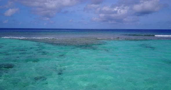 Gloomy day with grey clouds on sky and dark blue sea waving over calm turquoise lagoon in Antigua se alt