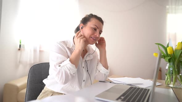Cute Girl in a White Shirt Has a Video Call in the Office alt