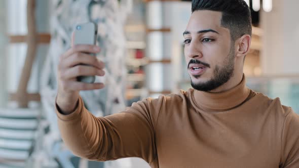 Young Guy Looking at Phone Screen Talking on Webcam Remote Communication Online Conference Virtual alt