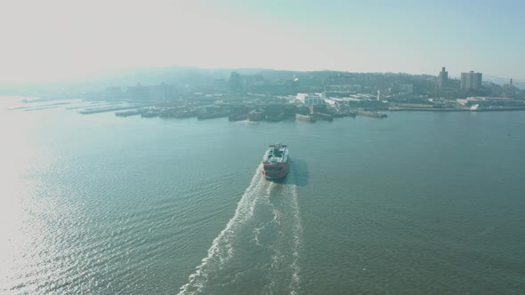Aerial Drone Shot Orbiting Staten Island Ferry in New York Harbor near Sunset