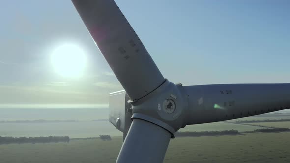 Wind Generator Turbine Blades Over Countryside Farm Fields