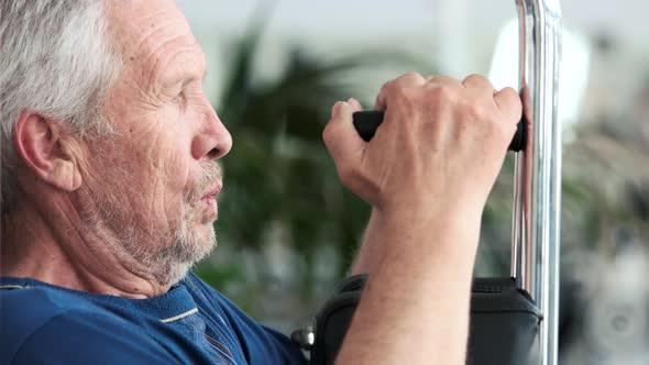 Close Up Old Man Doing Chest Exercise at Gym. alt
