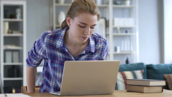 Woman Leaving Office after Completing Work on Laptop alt