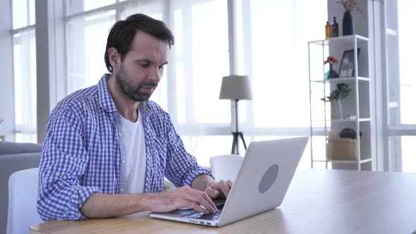No Casual Beard Man Rejecting By Shaking Head While Working on Laptop alt