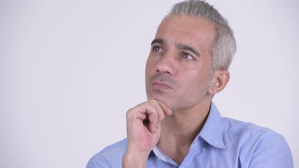 Happy Persian Businessman Thinking Against White Background alt