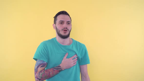 Young Man Having Heart Attack Holding Chest and Having Difficulty Breathing alt