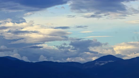 Timelapse Clouds Swirl Over Blue Mountains Snowy Peak in the Distance alt