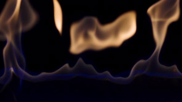Flash and Fire Streak of Flammable Liquid or Gasoline Against Black Reflective Background alt