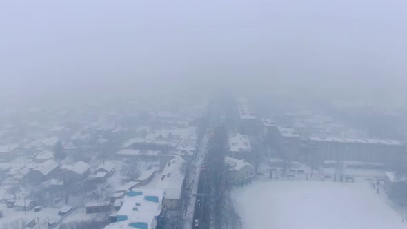 Aerial view of small town in snowfall. Blizzard. Snowstorm.