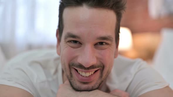 Close Up of Cheerful Young Man Smiling at Camera alt