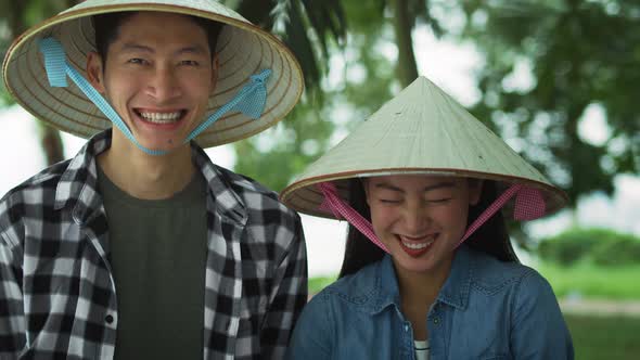 Handheld view of cheerful Vietnamese couple. Shot with RED helium camera in 8K alt