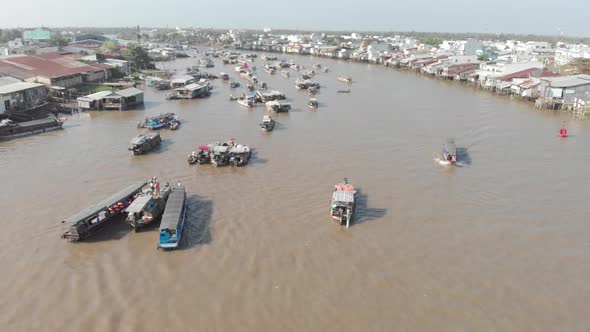 Aerial: flying over Cai Rang floating market on the river, Can Tho, Vietnam alt