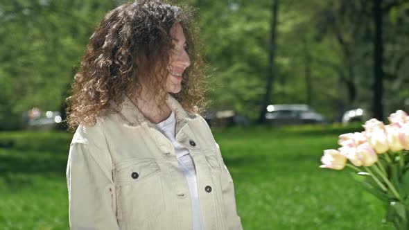 Teenage Girl Gives Her Mother a Large Beautiful Bouquet of Tulips alt