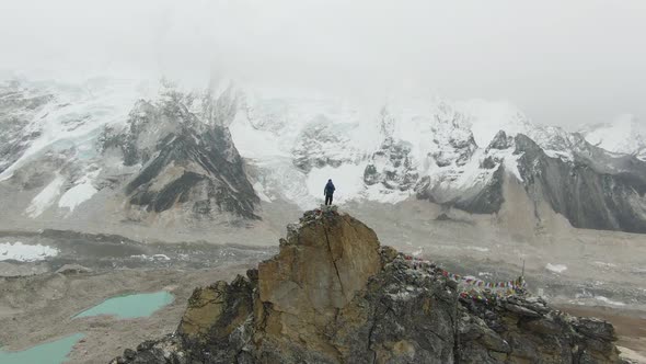 Man on Top of Kalapatthar Mountain. Everest and Nuptse. Nepal. Aerial View alt
