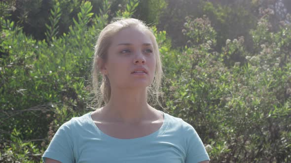 A young woman runner resting after jogging. alt