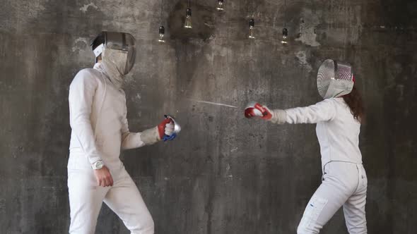 Two Sportsmen Are Engaged in Fencing in the Sports Center, the Pair Is Trained alt
