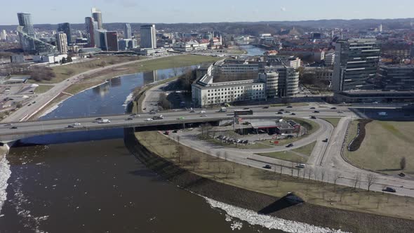 AERIAL: Roundabout Near River Neris in Vilnius with Cars Passing By on a Sunny Day