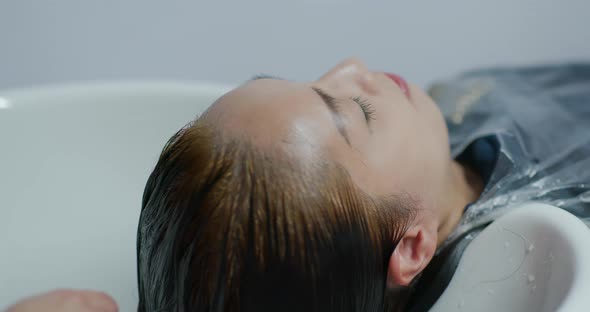 Woman wash her hair in salon