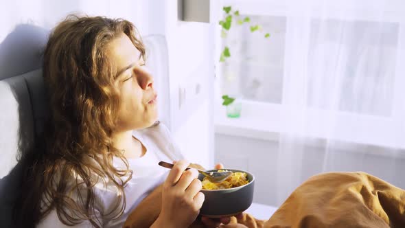 Woman Enjoying Sunny Morning Breakfasting in Bed