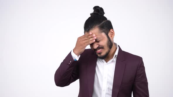 Frustrated and depressed Indian businessman thinking alt