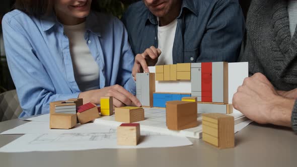 Kitchen Design Constructor. Young Woman Puts Miniature Fridge To Other Furniture. Young Family alt