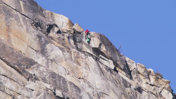 Man Climbing with Efforts Up El Capitan Mountain Expedition Tourism RED Footage alt