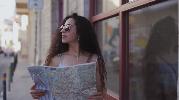 Young Woman with Map Doing Sightseeing in Old European Town