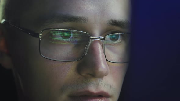 The Programmer Enthusiastically Looks at the Computer Screen alt