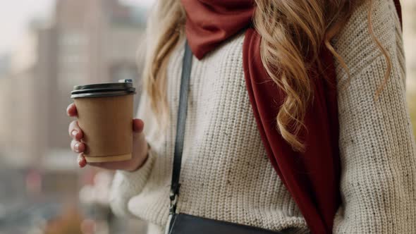 Beautiful Girl Having Coffee Outdoors. Hipster Woman Sipping Tea on Street. alt