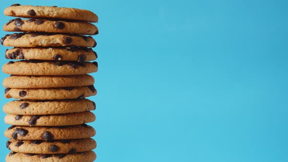 A Stack Chocolate Chip Cookies Rotate on a Blue Background alt