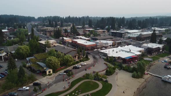 Counterclockwise drone shot of cars coming into the lakeside town of McCall, Idaho during sunset. Th alt