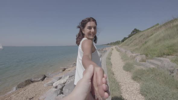 POV Shot of Girl Pulling Boyfriend Along The Beach His Hand in Slowmotion - Ungraded alt