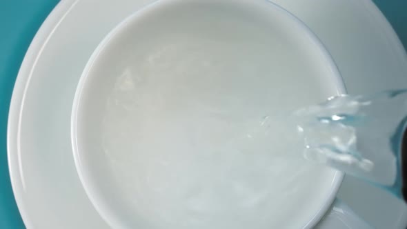 Pouring Hot Water Into Teacup alt