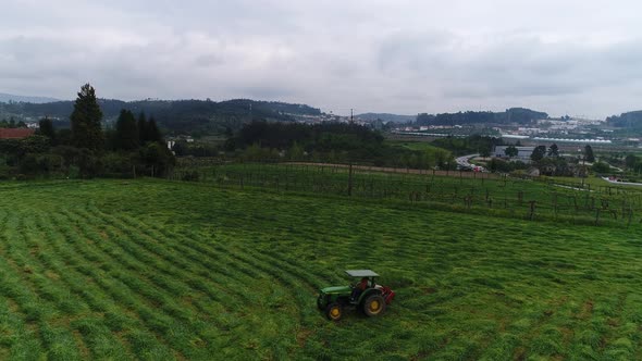 Farmer with Tractor working in Agriculture Field alt