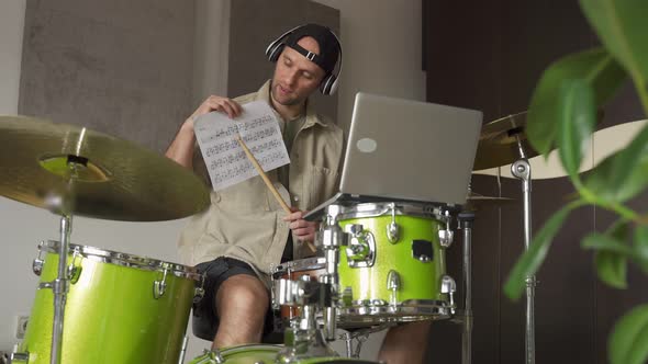 Man Gives Drum Lesson Via Laptop alt